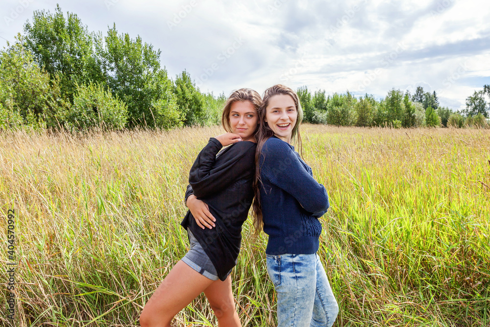 Summer holidays vacation happy people concept. Group of two girl friends dancing hugging and having fun together in nature outdoors. Lovely moments best friend.