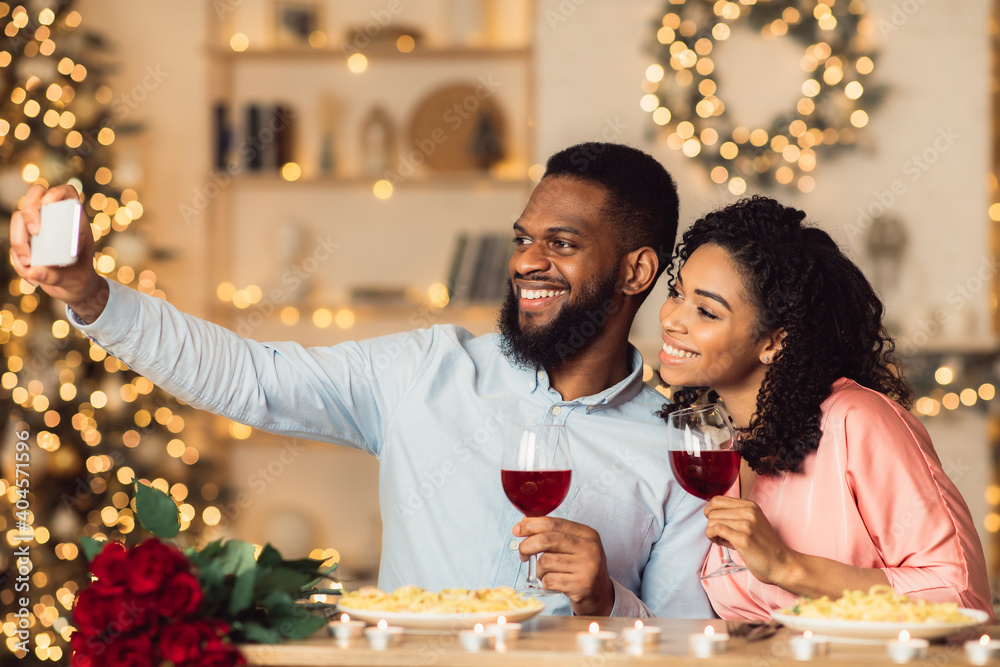 Smiling black man and woman taking selfie on a date Smiling black man and woman taking selfie on a date