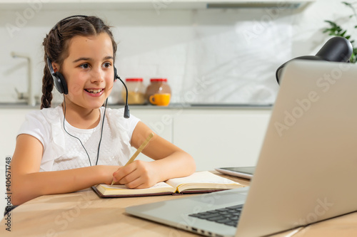 Kids distance learning. Cute little girl using laptop at home. Education  online study  home studying  technology  science  future  distance learning  homework  schoolgirl children lifestyle concept.