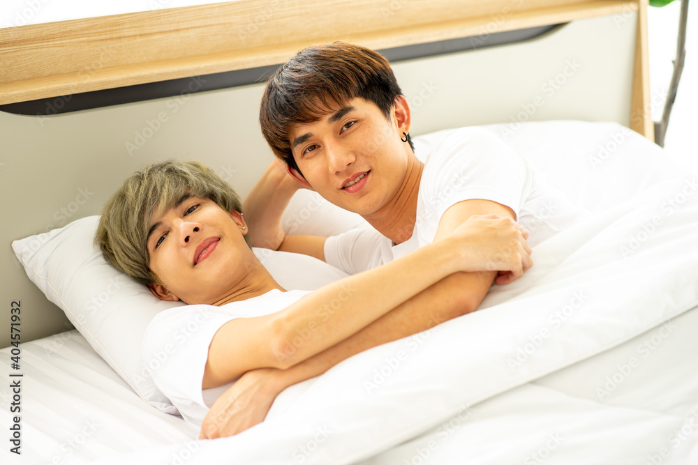 same sex couple lovers LGBTQ lying on bed together same sex couple lovers LGBTQ lying on bed together