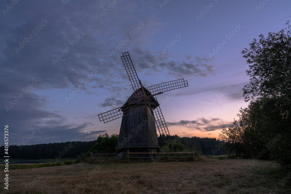 State museum-reserve of Alexander Pushkin «Mikhailovskoye». Beautiful russian landscape with an old windmill at sunset. July 2020.