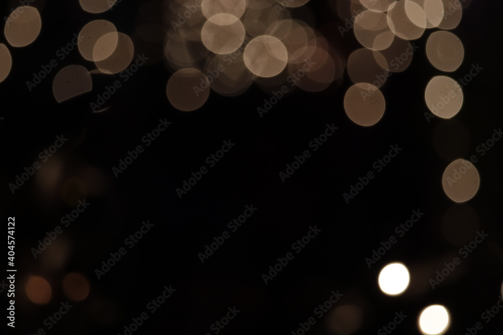 Black background blurred shimmering multicolor festive lights and space for text. This wallpaper design is good for presentation, websites, greeting cards to set the mood for festivity celebrations