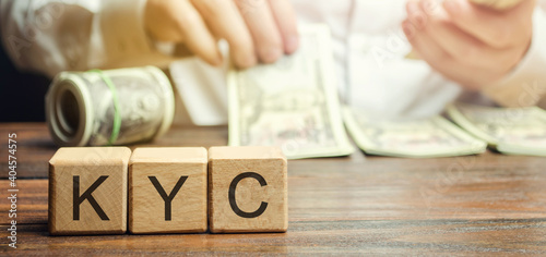 Wooden blocks with the word KYC - Know Your Customer / Client. Verify the identity, suitability and risks involved with maintaining a business relationship. Anti-bribery compliant photo