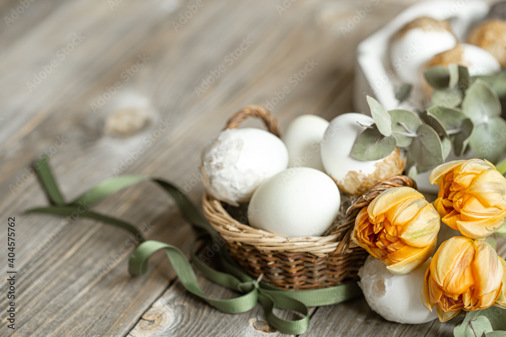 Spring easter composition with eggs in a basket and a bouquet of flowers close up. Spring easter composition with eggs in a basket and a bouquet of flowers close up.