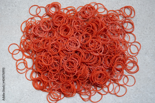 Big red circle rubber bands on a gray background.