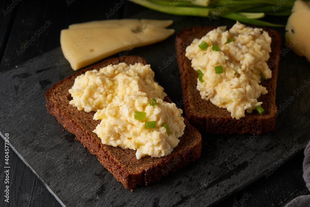 Scrambled eggs with green onion with gluten free bread on table Scrambled eggs with green onion with gluten free bread on table