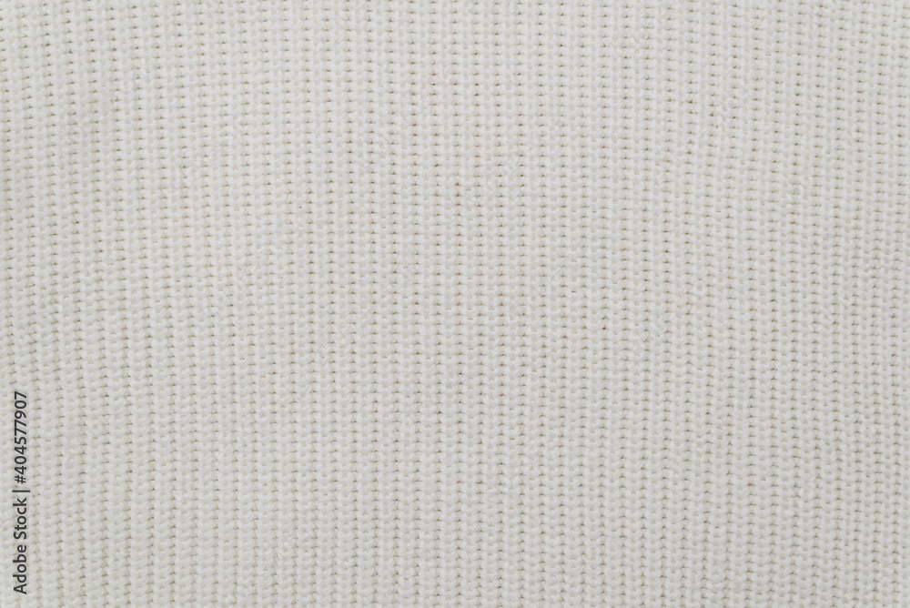 the background of a white knit fabric copy space. soft knitwear structure