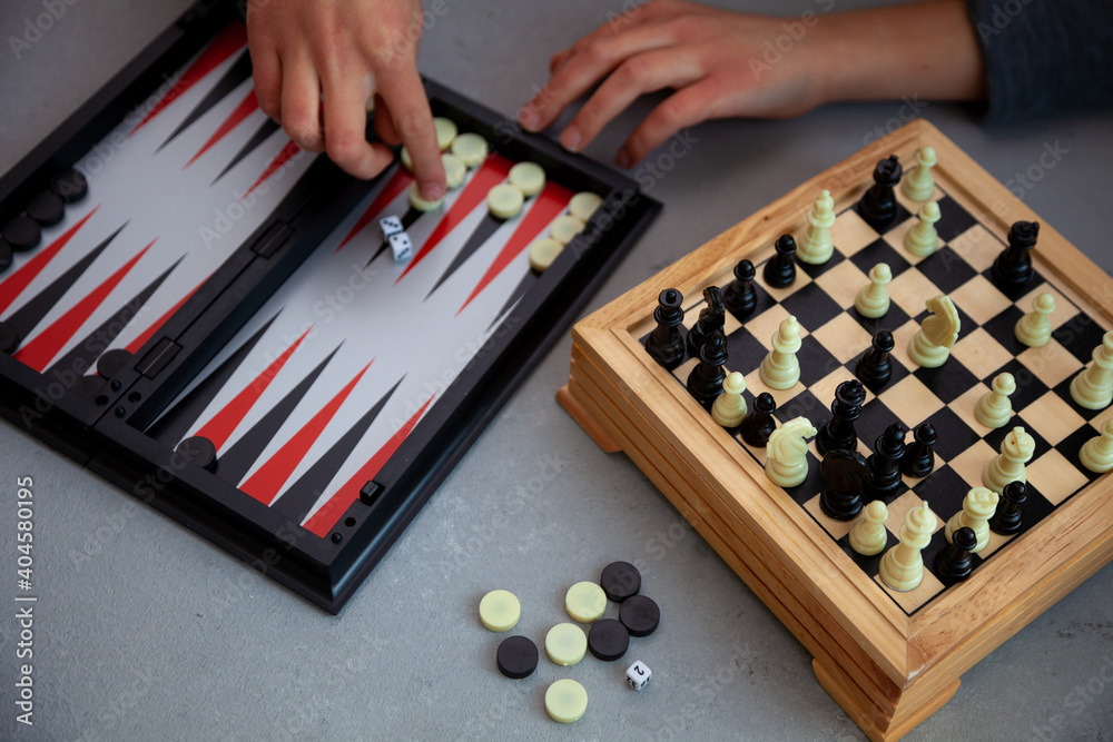 Board games on the table. Chess, backgammon, checkers. Boards are laid out for the game. Play, have fun at home. Leisure, hobbies. Board games on the table. Chess, backgammon, checkers. Boards are laid out for the game. Play, have fun at home. Leisure, hobbies.