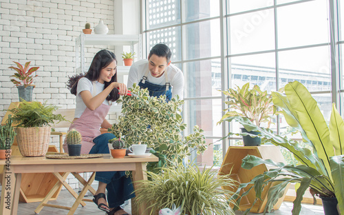 Young couple gardening plants together at home photo