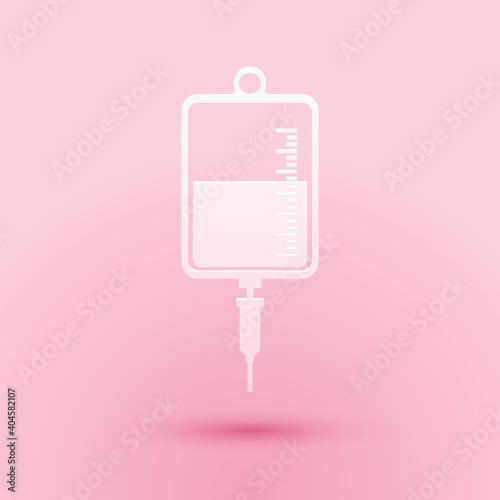 Paper cut IV bag icon isolated on pink background. Blood bag icon. Donate blood concept. The concept of treatment and therapy, chemotherapy. Paper art style. Vector.