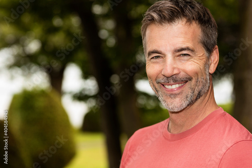 Old Mature Happy Man Smiling At The Camera. Outside