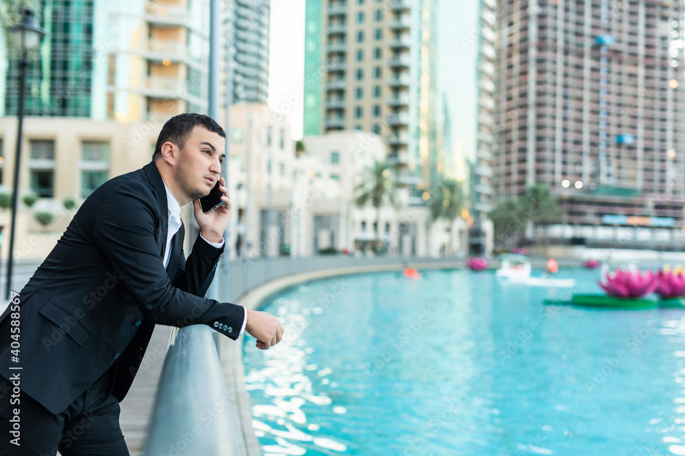 Young businessman have phone conversation outsida in the business district Young businessman have phone conversation outsida in the business district