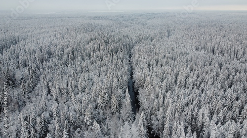 Sunset drone shot of the river in winter forest in Russia, Karelia