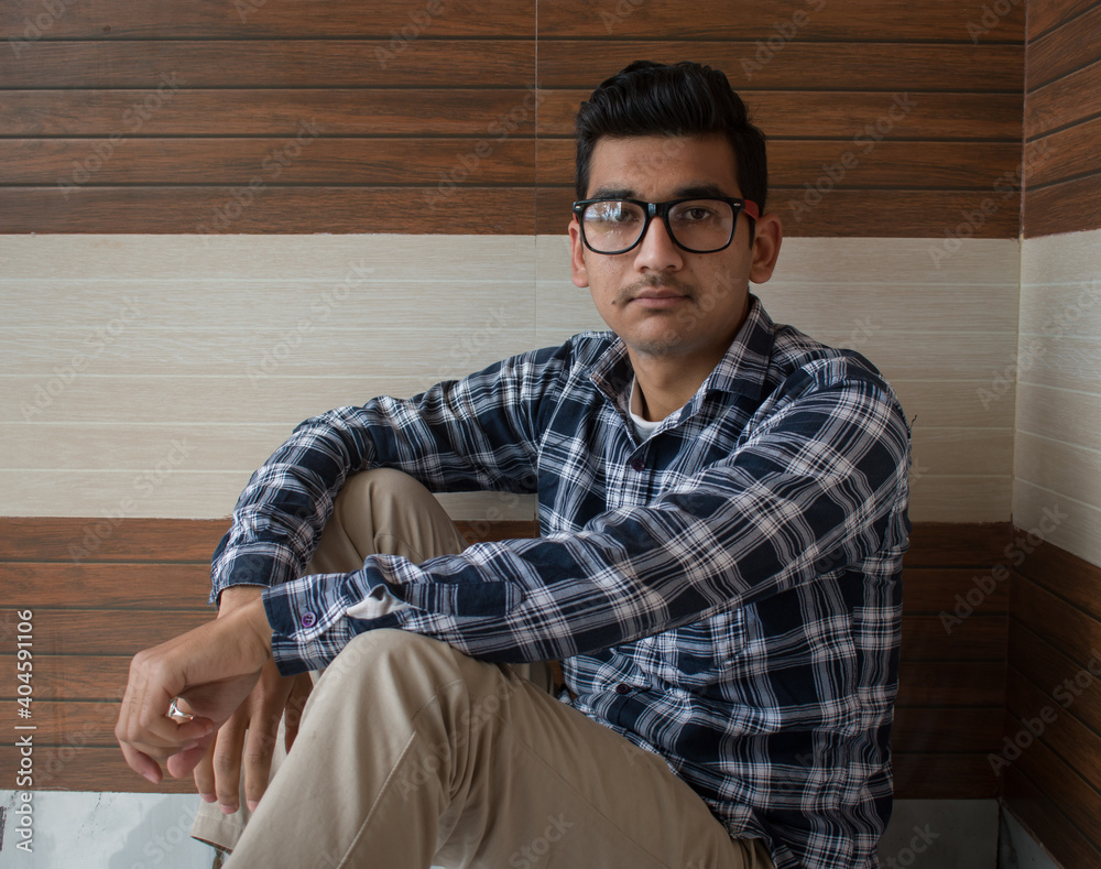 Fototapeta premium Indian boy looking at camera wearing checked blue shirt and cotton pant