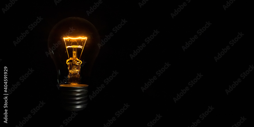 incandescent light bulb on black background incandescent light bulb on black background