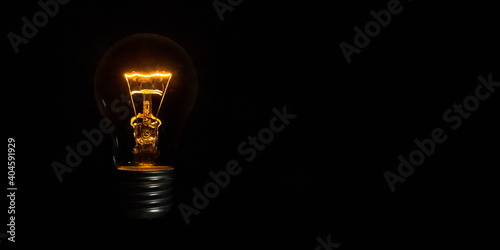 incandescent light bulb on black background