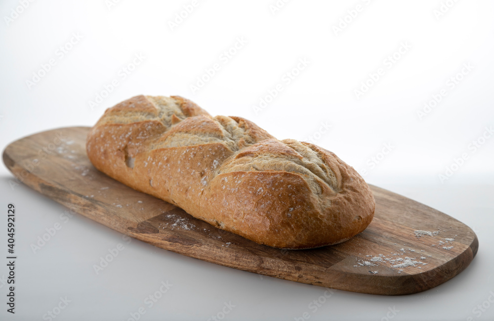Fresh white bread on a wooden cutting board