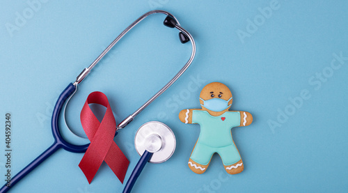 red ribbon symbol of the fight against AIDS on a blue background