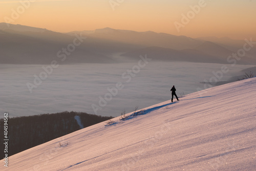 hiker on a mountain slope in winter