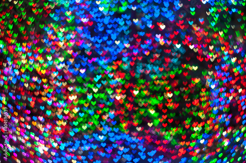 Color Bokeh on a dark background with hearts for use in graphic design