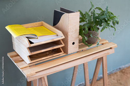 Foto Paper and document wooden tray holders and organisers on desk, natural decor concept