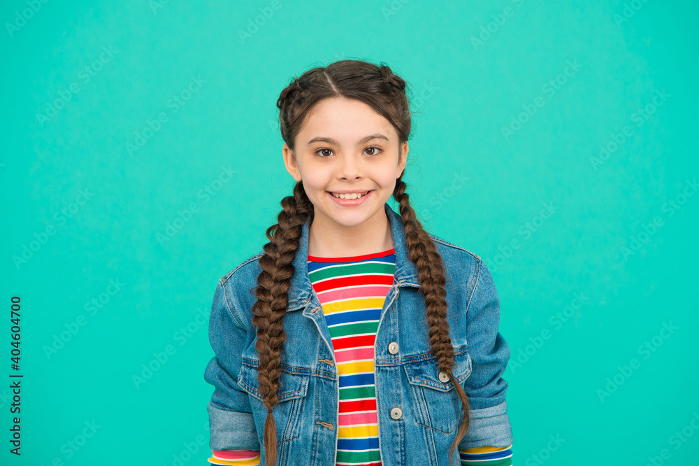 Φωτογραφία Happy child with cute smile wear long hair in plaits in casual fashion style blu