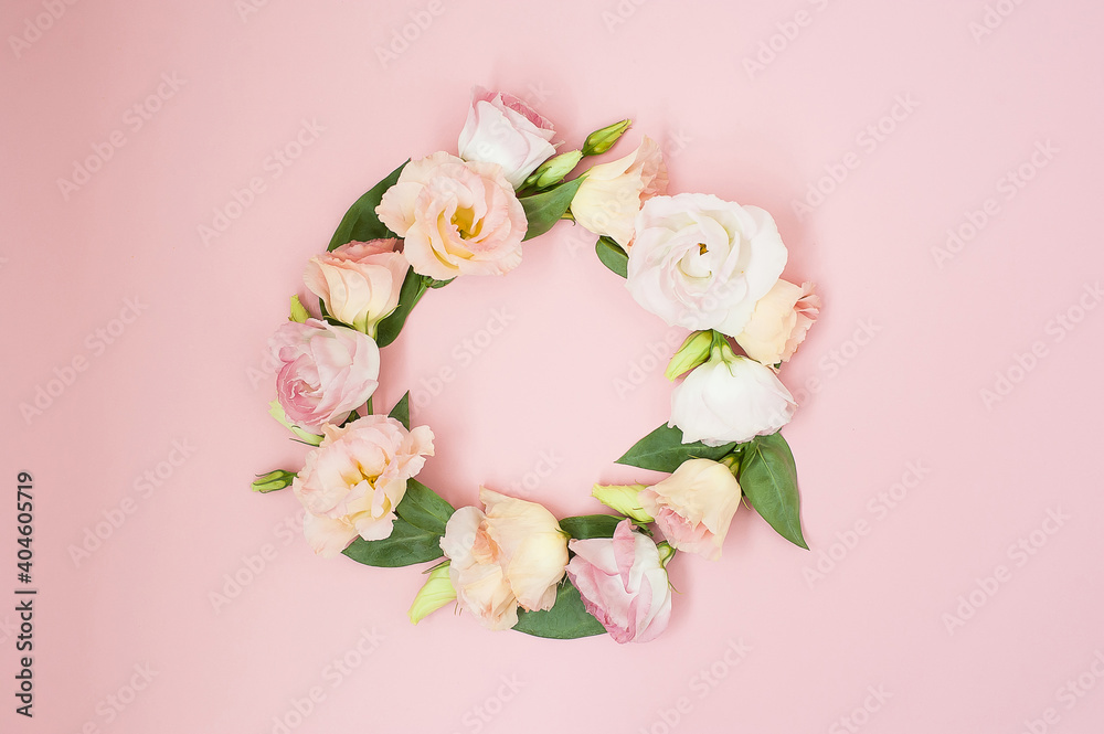 Creative layout made with pink flowers wreath on pastel pink background. Flat lay. Top view, frame with copy space. Creative layout made with pink flowers wreath on pastel pink background. Flat lay. Top view, frame with copy space.