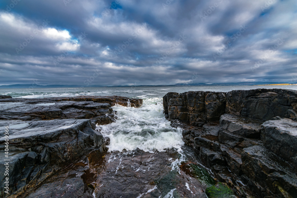 The Atlantic ocean waves crashing in to the cliffs off the west coast of Ireland, County Donegal,  Creavy pier