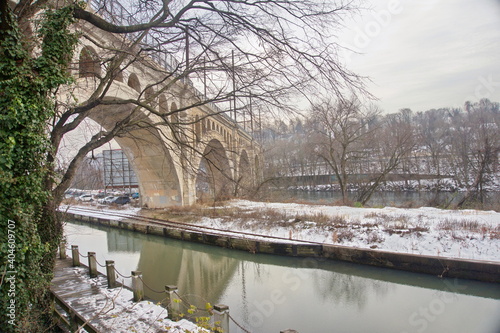 Arched Bridge Over Canal and River photo