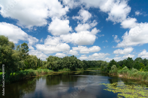 Daytime landscape, river and clouds on a sunny day