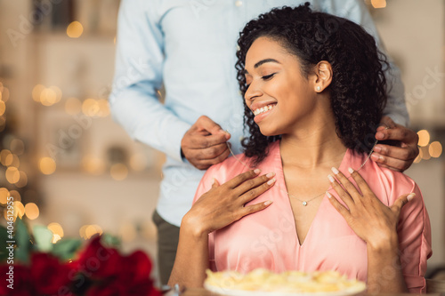 Photography Young black guy wearing necklace on his happy woman