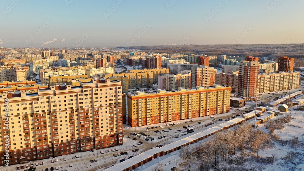 Fototapeta premium Tall new buildings in a Russian winter city. New residential areas of Penza with houses in winter. Sleeping area of the city of Penza. Penza city from above.