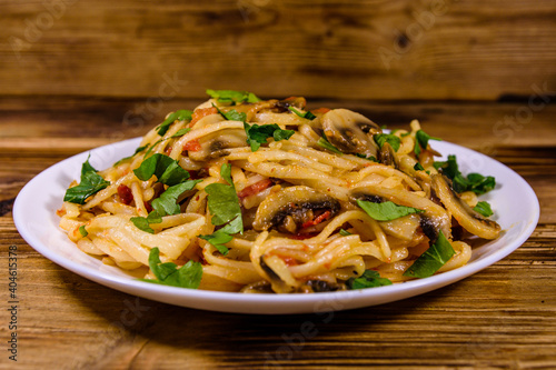 Pasta with mushrooms and tomato sauce in a plate