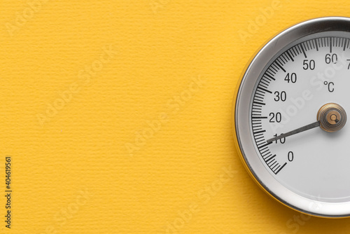 Water temperature meter on the yellow abstract background.