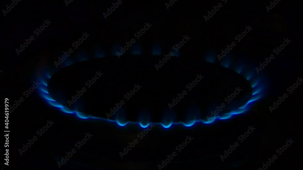Gas stove switching on, apearing blue flame on black background. Gas stove switching on, apearing blue flame on black background.