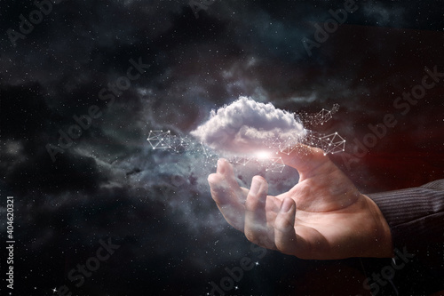 Hand shows clouds on the background of outer space.
