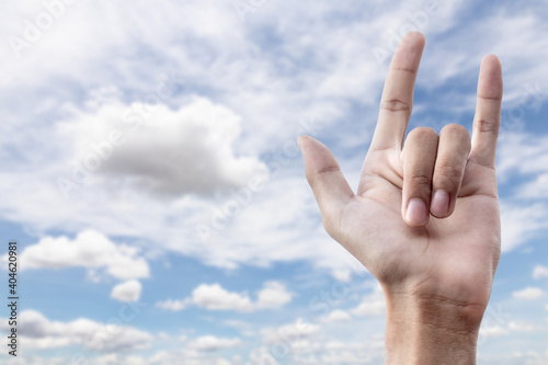 love hand sign on blue sky background with cloudy. I love you concept.