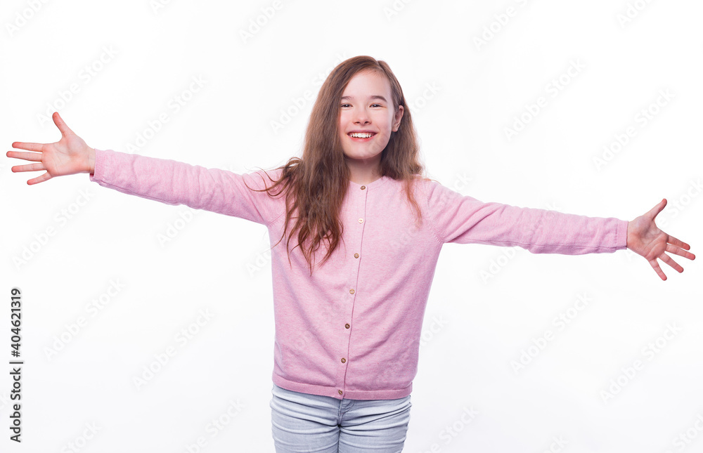 Excited young girl is standing with arm wide open ready for a hug over white background. Excited young girl is standing with arm wide open ready for a hug over white background.