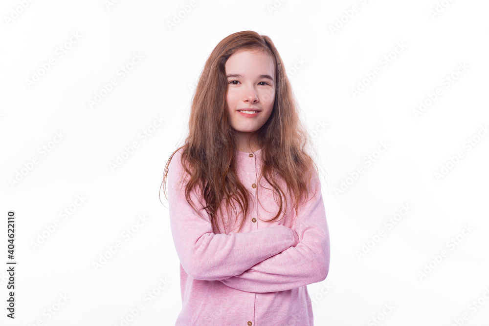Portrait of little girl standing with crossed arms over white background and looking at the camera. Portrait of little girl standing with crossed arms over white background and looking at the camera.