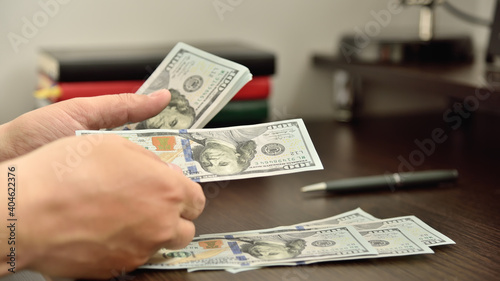 Businessman in office counts money