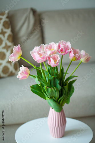 Bouquet of beautiful tulips in a vase in a home interior.