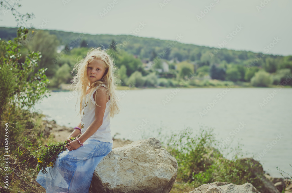 beautiful girl enjoying sunny summer day in green meadow by the river beautiful girl enjoying sunny summer day in green meadow by the river