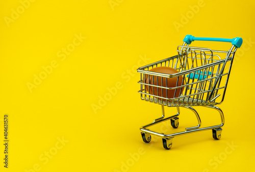Brown chicken egg in small shopping trolley, Mini cart with one egg inside