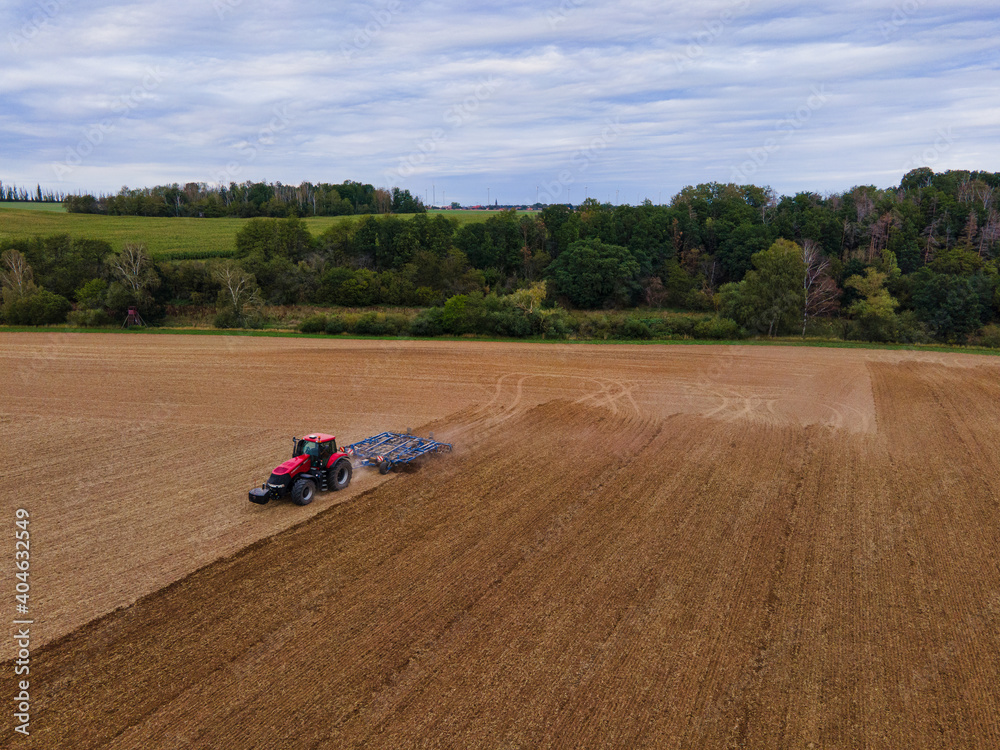 Ταπετσαρία Farmer with tractor on wide field tilling the soil