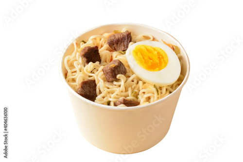 Paper cup with instant ramen noodles with beef and vegetables.