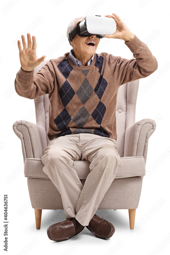 Elderly gentleman sitting in an armchair and using a VR headset