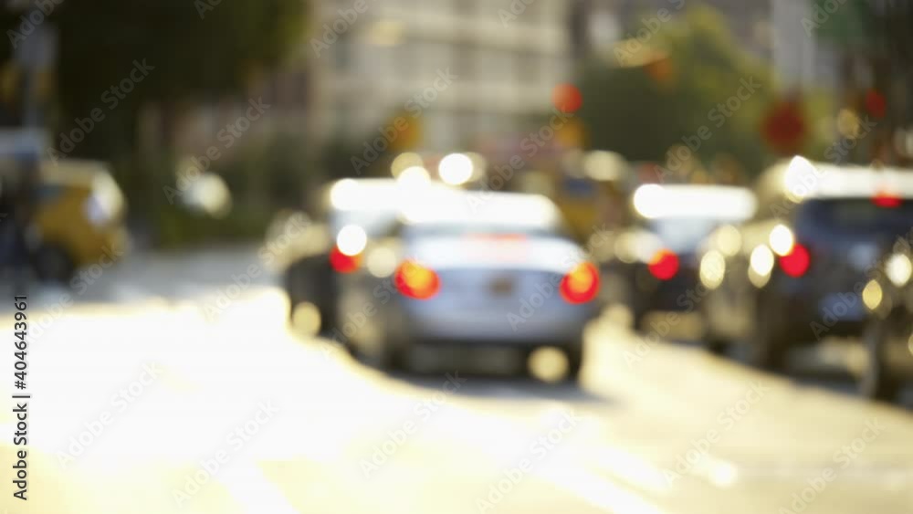 New York City busy crossroads, blurry street traffic, cars and pedestrians, sunny day