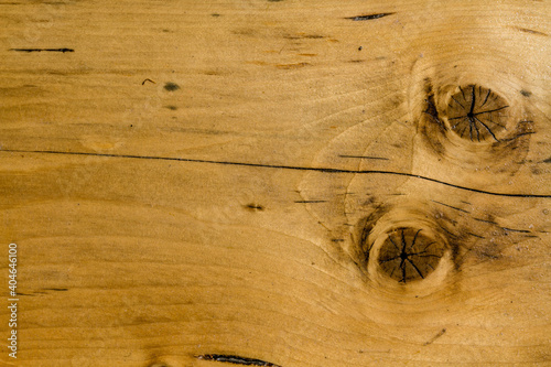 Wooden texture in close up shot. Orange wooden texture with two circles.