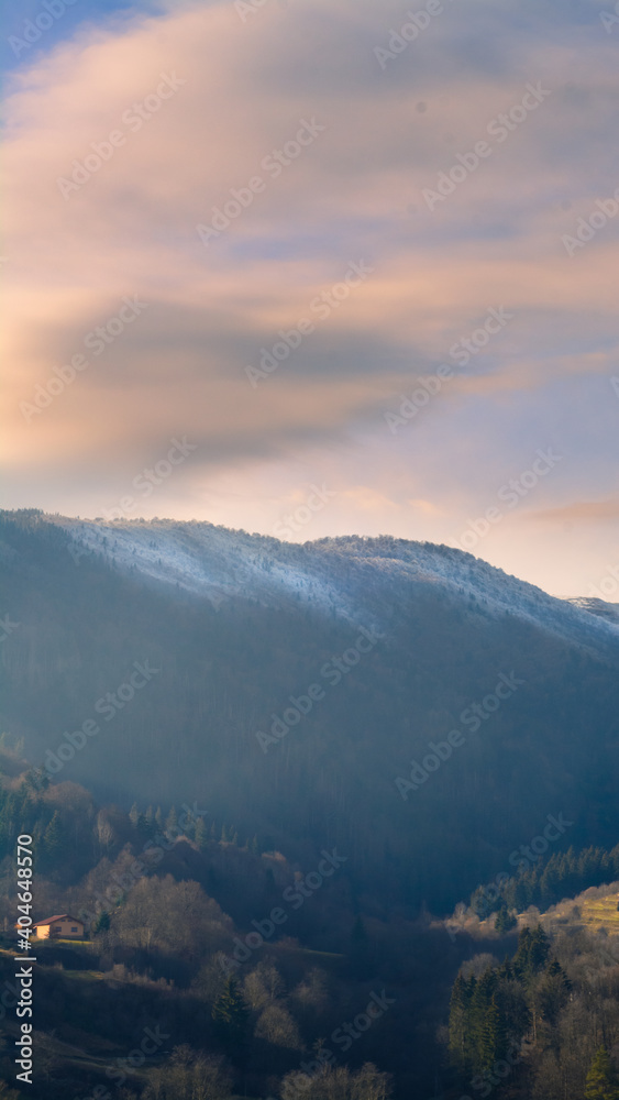 landscape with mountains and clouds at sunrise