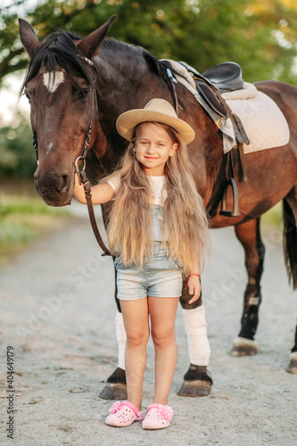Friendship of a child with a horse. Treating autism with a horse. Interaction of a girl with autism and a horse. Walking a child with a horse in the fall.
